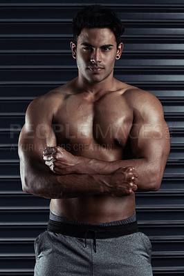 Buy stock photo Cropped portrait of an athletic young man posing against a dark background
