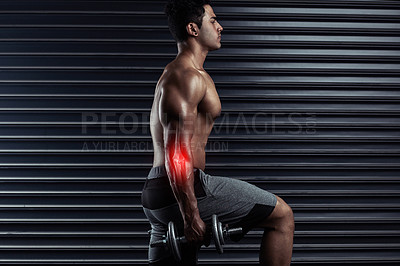 Buy stock photo Cropped shot of an athletic young man working out with dumbbells