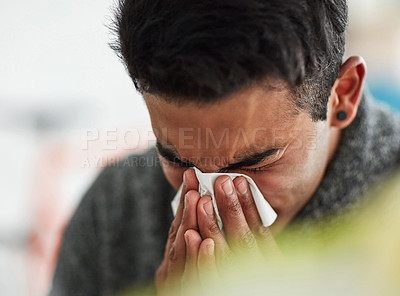 Buy stock photo Sick, hands and blowing nose with a man using a tissue closeup in his home for relief from allergy symptoms. Face, cold or flu and a young person ill with a virus due to bacteria, pollen or hay fever