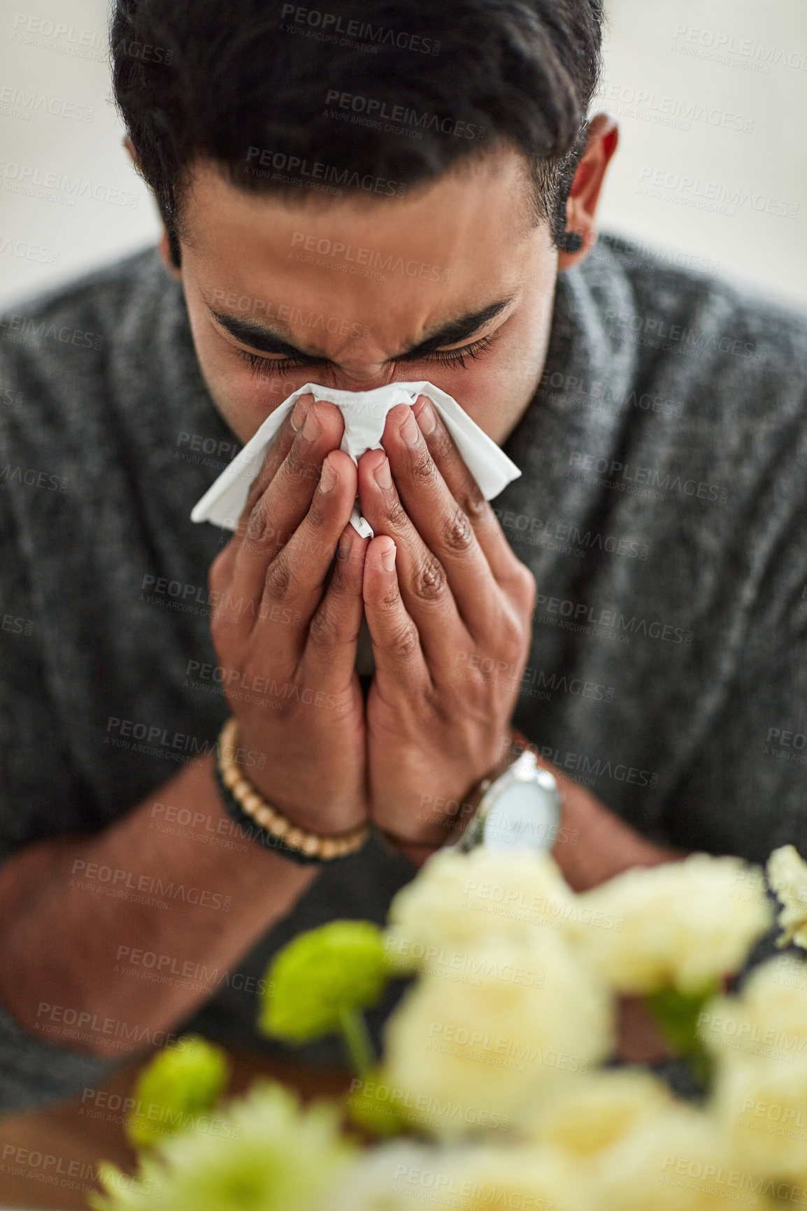 Buy stock photo Spring, blowing nose with a man using a tissue closeup in his home for relief from allergy symptoms. Face, cold or flu and a young person sick with a virus due to pollen or hay fever at home