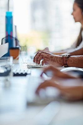 Buy stock photo Cropped shot of a group of workers sitting at their desk