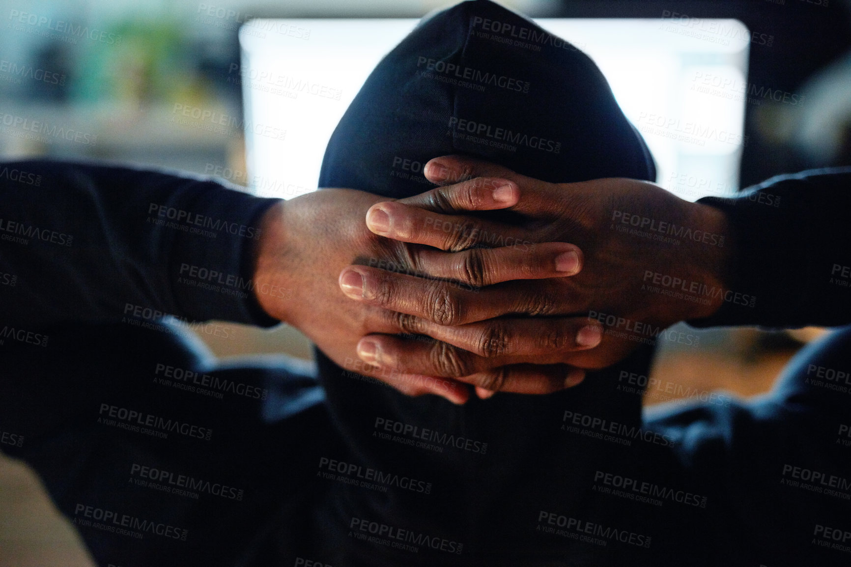 Buy stock photo Rearview shot of an unidentifiable hacker cracking a computer code in the dark