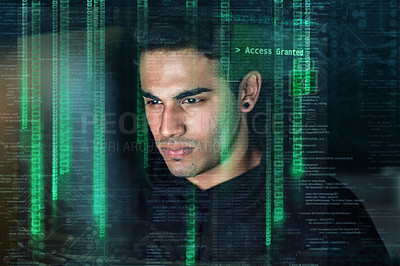 Buy stock photo Shot of a young hacker cracking a computer code in the dark