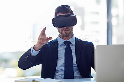 Buy stock photo Shot of a businessman wearing a VR headset while working in his office