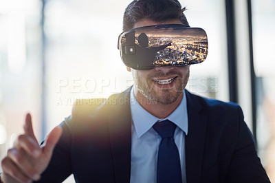 Buy stock photo Shot of a businessman wearing a VR headset while working in his office