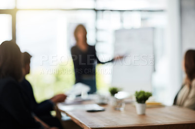 Buy stock photo Defocussed shot of a team of businesspeople attending a meeting in the boardroom