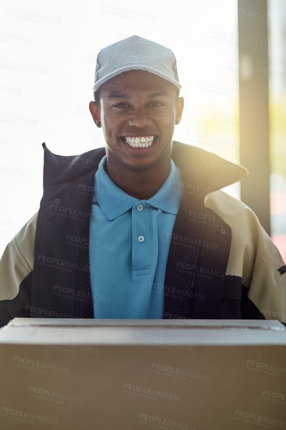 Buy stock photo Portrait of a courier holding a box for delivery