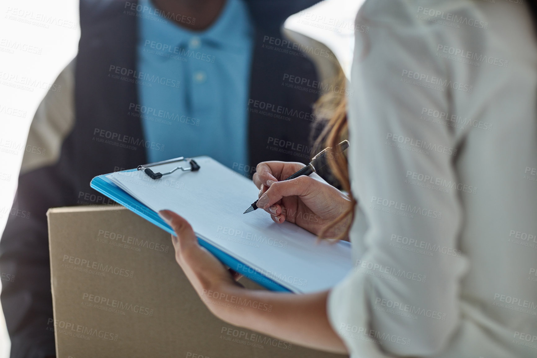 Buy stock photo Cropped shot of a businesswoman signing for a package delivered by a courier to her office