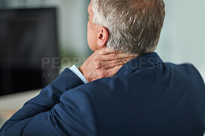 Buy stock photo Rearview shot of a mature businessman rubbing his neck in the office