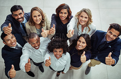 Buy stock photo Portrait of a diverse group of businesspeople showing thumbs up in an office
