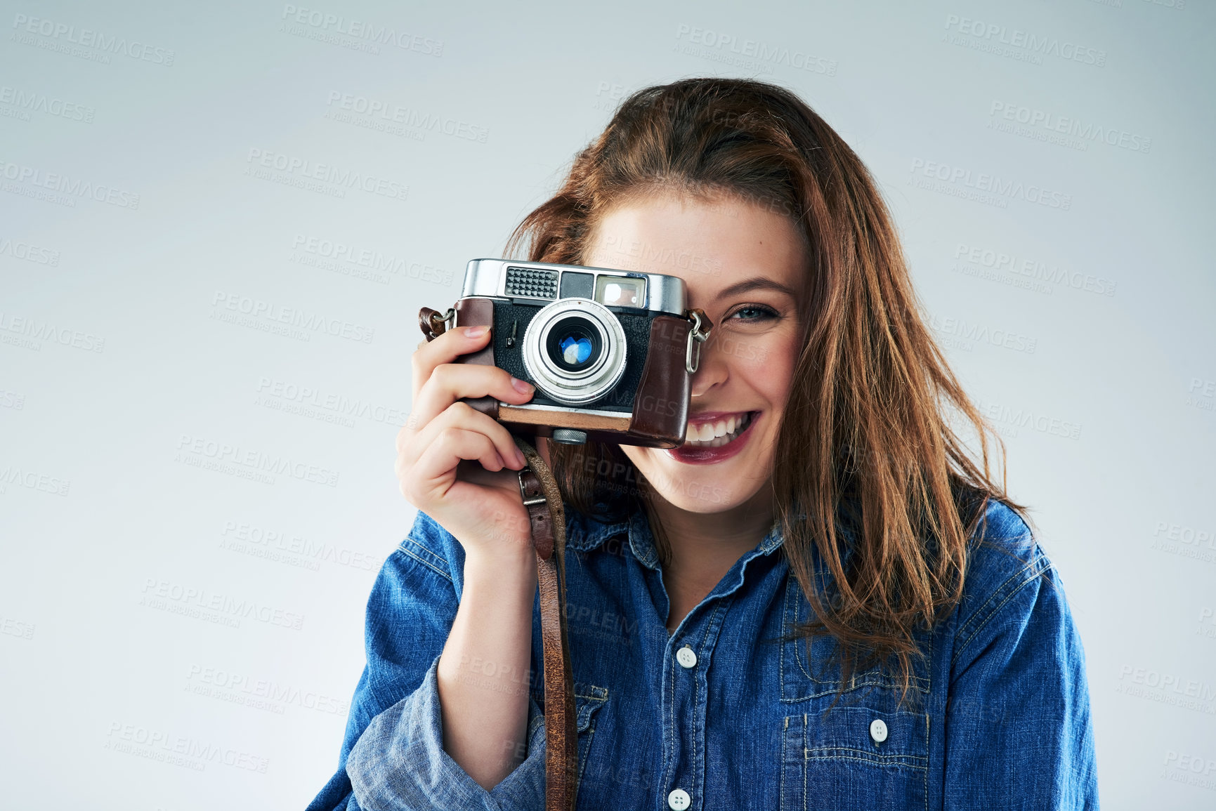 Buy stock photo Woman, portrait and vintage camera in studio for newspaper, magazine and press job at media company. Girl, paparazzi and retro tech for photoshoot, creativity and smile for story by white background