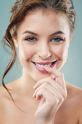 Buy stock photo Studio shot of a beautiful young woman against a gray background