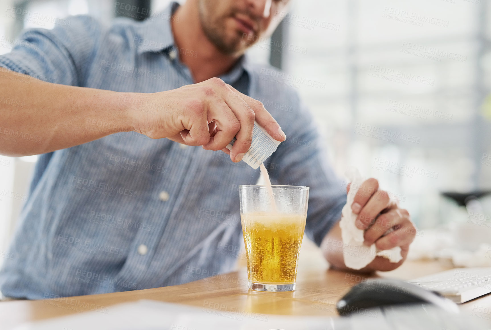 Buy stock photo Cropped shot of an unrecognisable businessman dissolving a sachet of medicine in a glass of water in an office