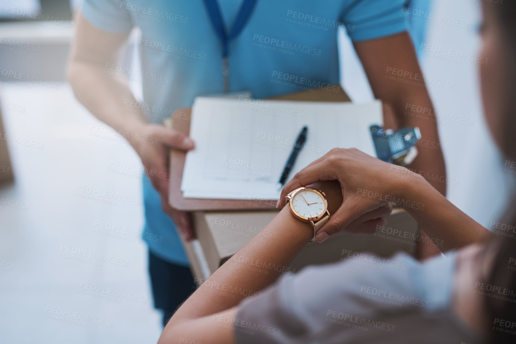 Buy stock photo Cropped shot of an unidentifiable businesswoman checking the time on her watch as the courier arrives with a delivery