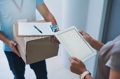 Buy stock photo Cropped shot of an unidentifiable businesswoman using a tablet to sign for a package delivered to her office