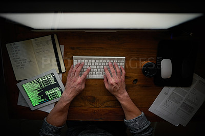 Buy stock photo High angle shot of an unidentifiable computer programmer working alone late at night