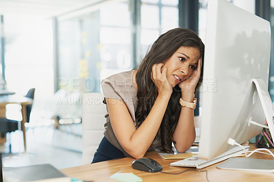 Buy stock photo Shot of an overwhelmed businesswoman looking at her computer in dismay