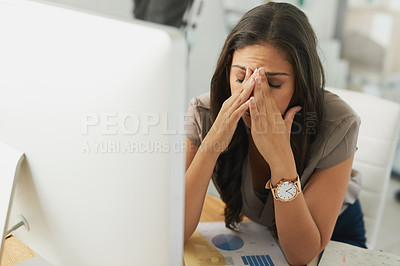 Buy stock photo Shot of an overwhelmed businesswoman sitting by her computer in the office