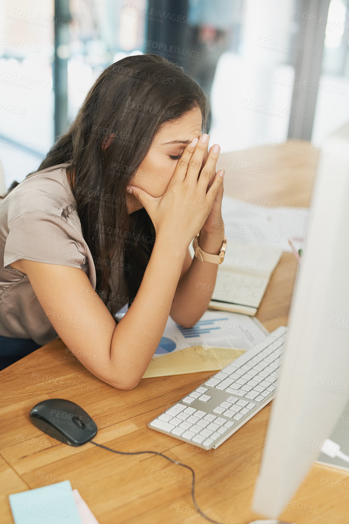 Buy stock photo Shot of an overwhelmed businesswoman sitting by her computer in the office