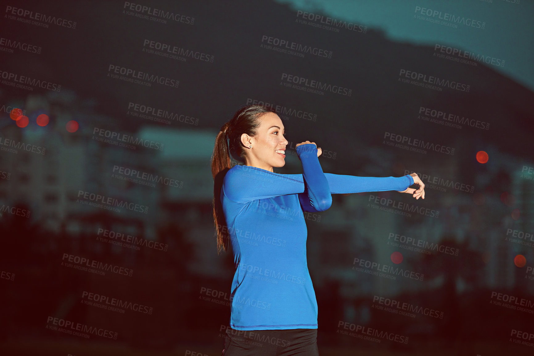 Buy stock photo Shot of a sporty young woman stretching before her run