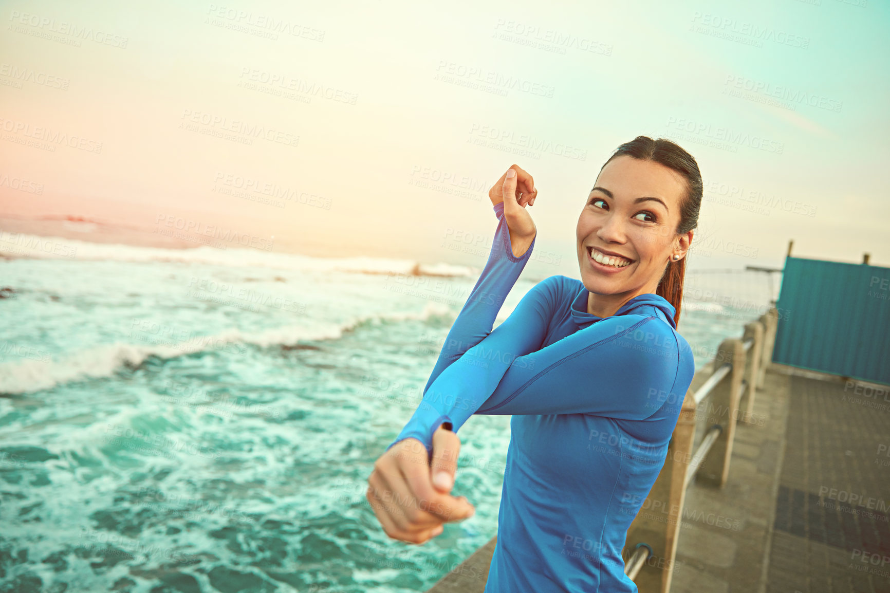 Buy stock photo Shot of a sporty young woman stretching before her run