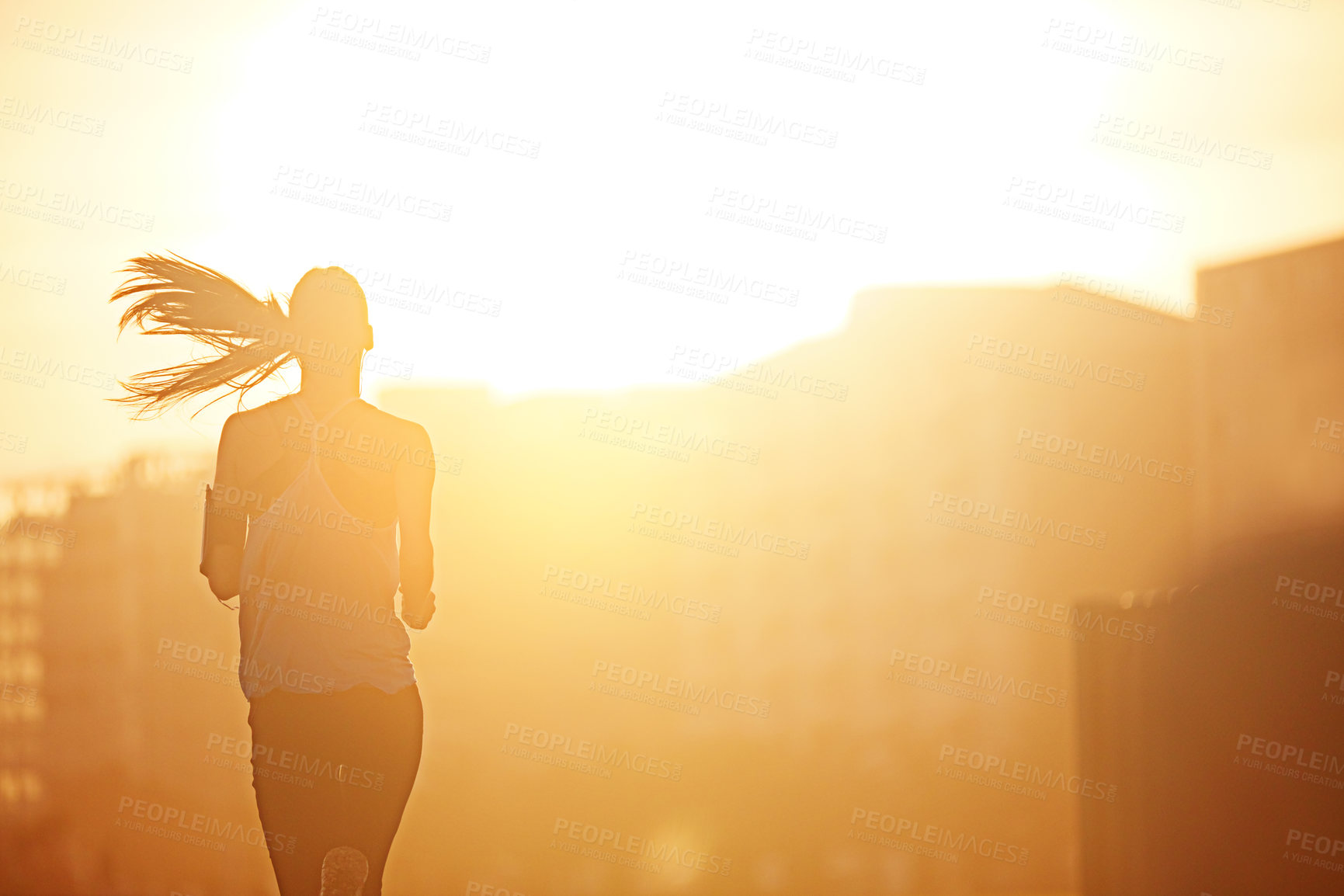 Buy stock photo Woman, running and silhouette in sunrise for exercise with fitness, development or speed by buildings in city. Girl, person and athlete with training, workout and outdoor on metro road by skyscraper