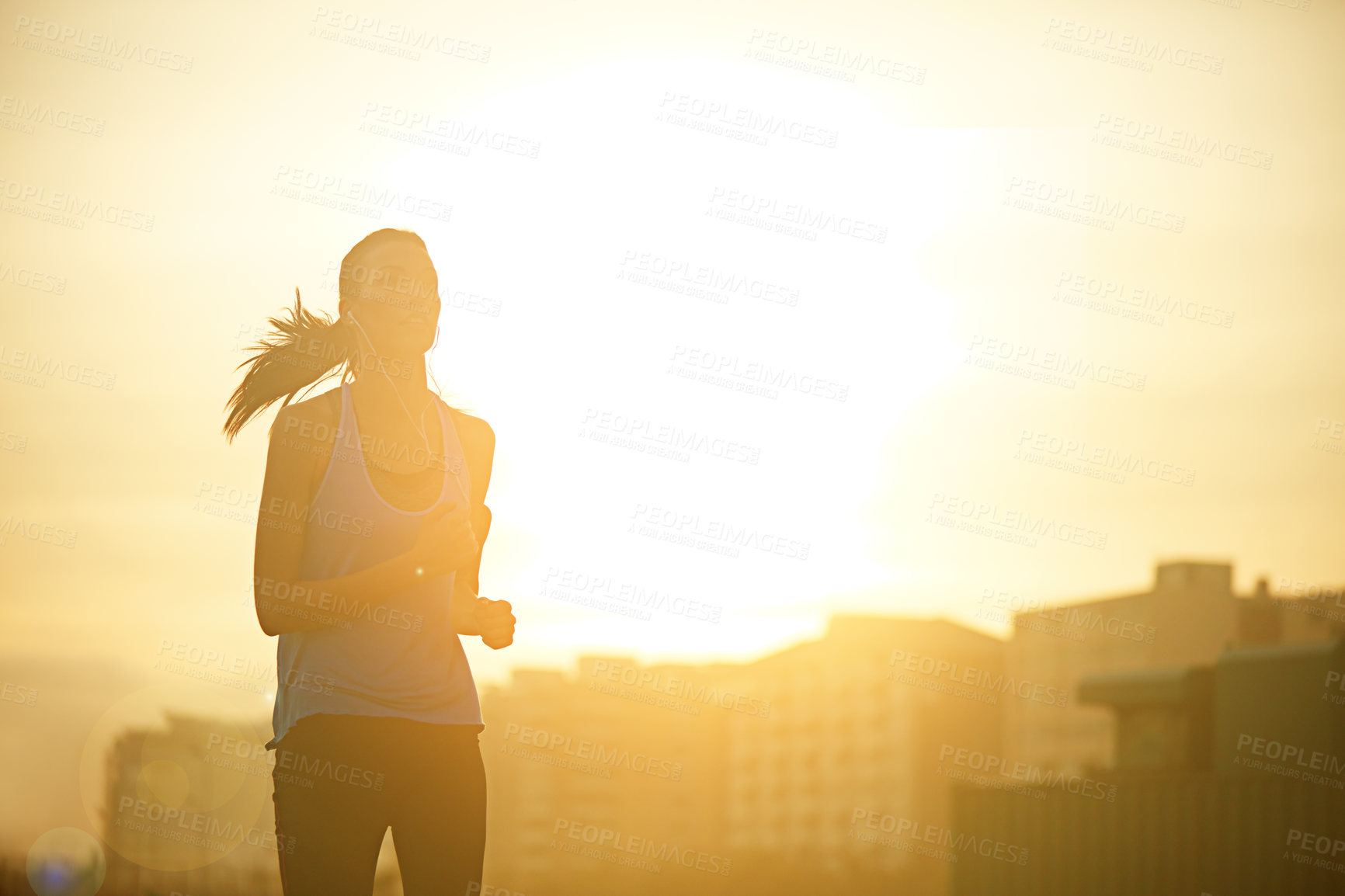 Buy stock photo Woman, running and silhouette in sunrise for workout with mockup space on sky background in city. Girl, person and athlete with training, exercise and earphones for music streaming in metro street