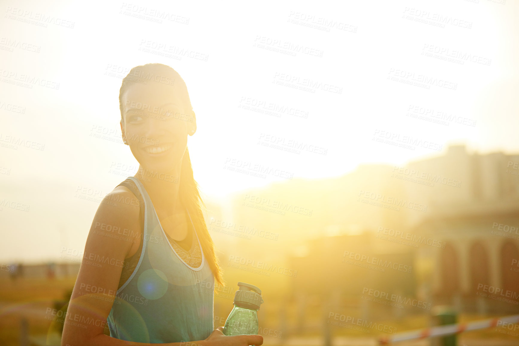 Buy stock photo Woman, runner and water bottle with smile for exercise with thinking, morning and natural detox in city. Girl, person and athlete in training, workout or space in sky on metro road with healthy drink