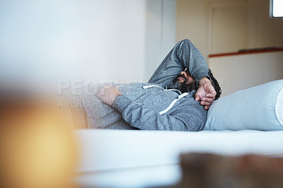 Buy stock photo Tired, insomnia and a man with stress on a bed with burnout, sad and mental health problem. Fatigue, depression and a person sleeping in the bedroom of a house while depressed or sick with a hangover