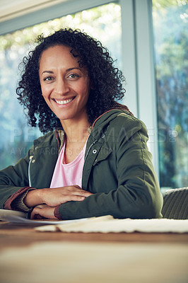 Buy stock photo Portrait of a relaxed mature woman sitting at a table outside on the patio