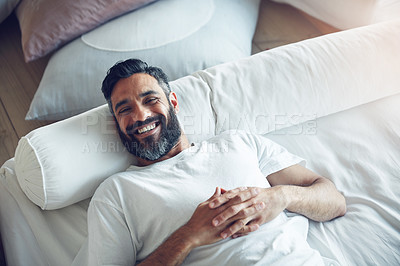 Buy stock photo Top view, portrait and man on his bed, relax and smile on a break, chilling and cheerful at home. Face, male person and happy guy in his bedroom, resting and wellness with joy, happiness and morning