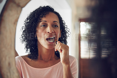 Buy stock photo Woman, brushing teeth and oral hygiene in mirror in routine, bathroom and dental care for healthcare. Female, reflection and fresh breath for wellness, cleaning and grooming gum, tooth and mouth