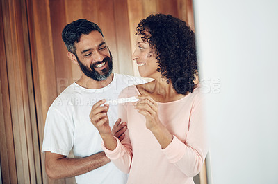 Buy stock photo Couple, happy and positive pregnancy test at home, hug and excited for family, future and love. Smiling parents, success and pregnant by ivf, fertility and support, results and celebration for baby