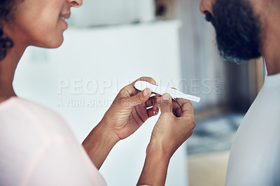 Buy stock photo Couple, hands and waiting for pregnancy test, results and excited with smile, anxiety and check stick in home. Woman, man and medical inspection with hope, thinking and ideas for baby in bathroom