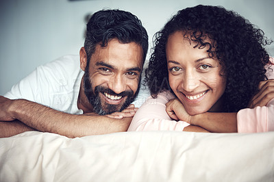 Buy stock photo Portrait of a mature couple relaxing together on the bed at home