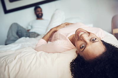 Buy stock photo Shot of a mature couple relaxing together on the bed at home