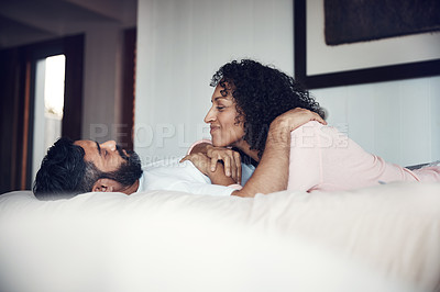 Buy stock photo Shot of a mature couple relaxing together on the bed at home