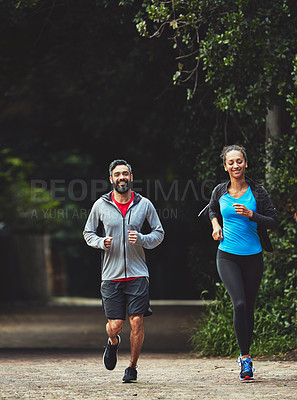 Buy stock photo Couple, running in park for fitness and health outdoor, support and training for marathon with cardio. Runner, athlete and sport with people in nature, challenge and exercise with workout for race