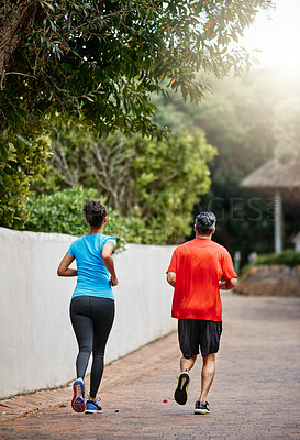 Buy stock photo Rearview shot of a couple out for a run