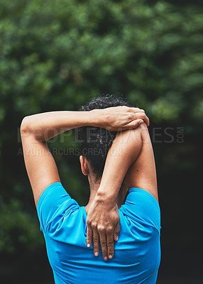 Buy stock photo Rearview shot of a woman stretching before her run