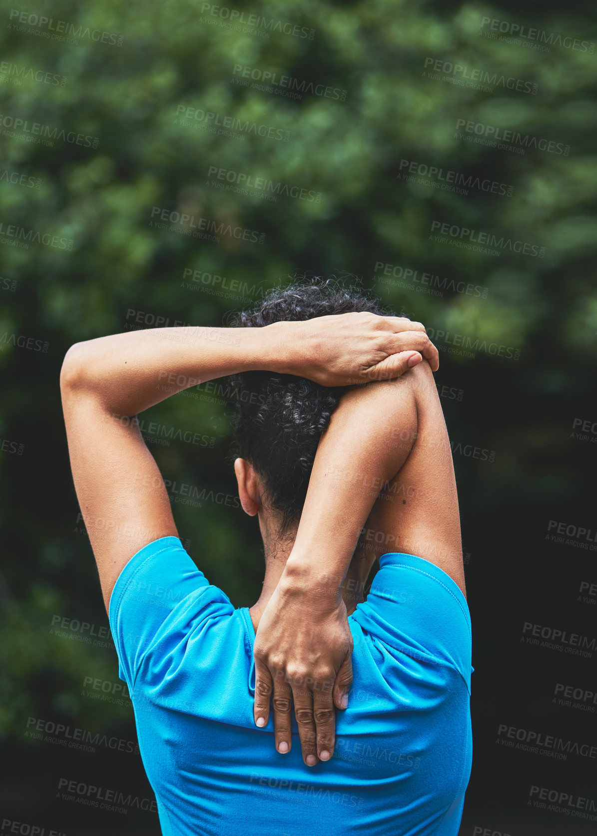 Buy stock photo Rearview shot of a woman stretching before her run