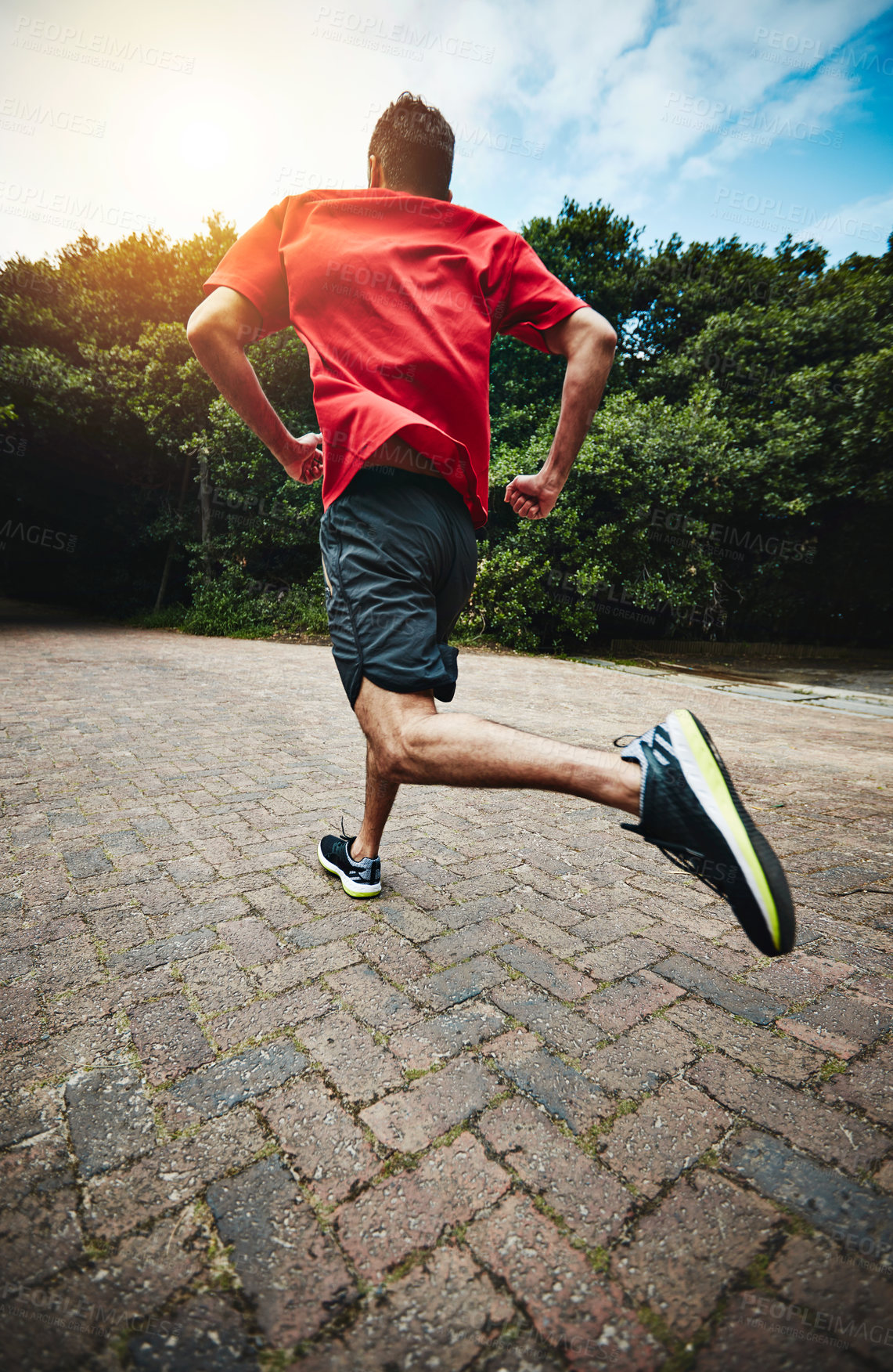 Buy stock photo Rearview shot of a man out for a run