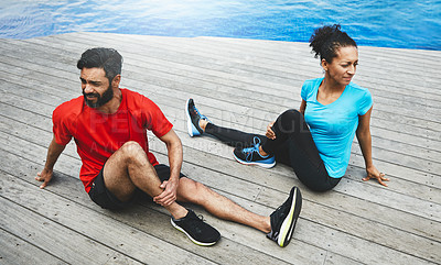Buy stock photo Shot of a couple stretching before their workout