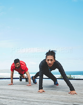 Buy stock photo Shot of a couple doing push-ups
