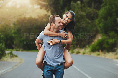 Buy stock photo Piggyback, love or happy couple walking on road or date with smile for romance, summer or adventure. Portrait, trust or man with woman on holiday vacation for bond, support or wellness on street