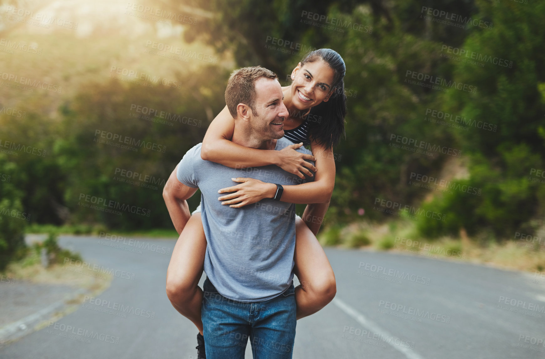 Buy stock photo Piggyback, love or happy couple walking on road or date with smile for romance, summer or adventure. Portrait, trust or man with woman on holiday vacation for bond, support or wellness on street