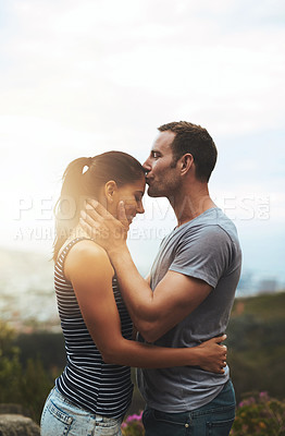 Buy stock photo Forehead, love or happy couple kiss in nature outdoor date with loyalty for romance, care or respect. Mockup space, trust or man with woman together on holiday vacation for bond, support or wellness