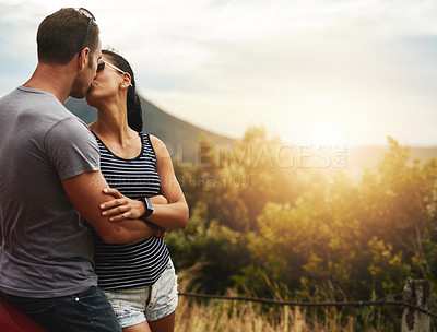 Buy stock photo Kiss, love or couple in nature for date, support or care on a summer romance or safari park adventure. Marriage, hug or man with woman on outdoor holiday vacation together for bond, travel or freedom