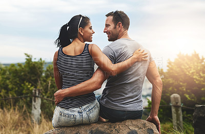 Buy stock photo Shot of a young couple enjoying a romantic day outdoors