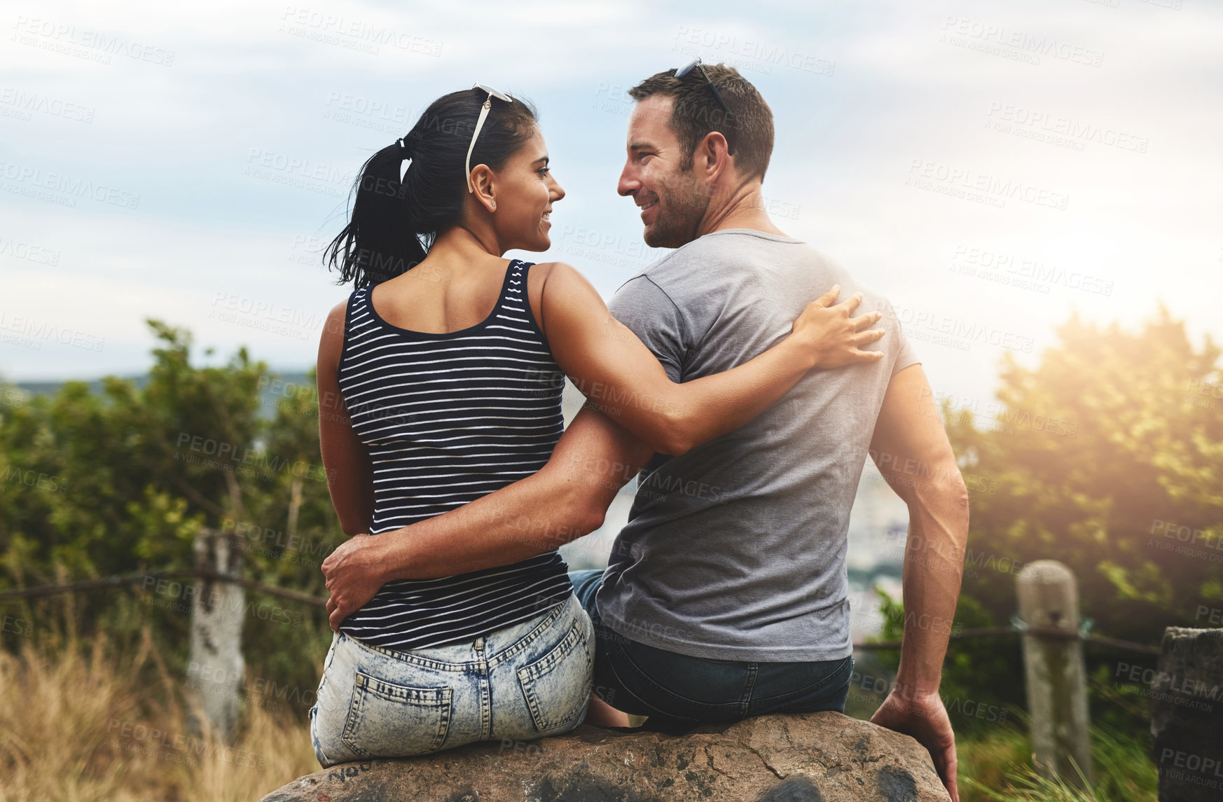 Buy stock photo Shot of a young couple enjoying a romantic day outdoors